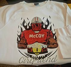 a white shirt with the words mccy on it and an image of a football player