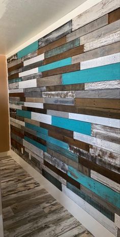 a wall made out of wooden planks and painted blue, brown and white colors