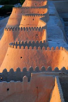 a castle like structure is lit up by the sun