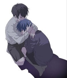 two people are hugging each other while sitting on the ground with their arms around one another