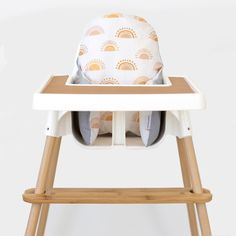 a baby high chair with an infant seat cover on it's back and legs