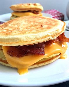 two pancakes with bacon and cheese on them