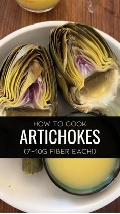 artichokes on a plate next to a glass of orange juice