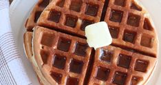 a waffle topped with butter and syrup on a white plate