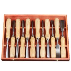 a wooden box filled with different types of knives