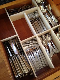 an open drawer filled with silverware and utensils