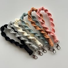 four different colored braided lanyards on white background