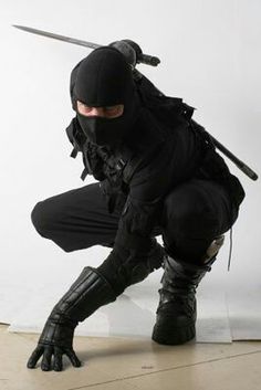 black and white photograph of a man in ninja gear