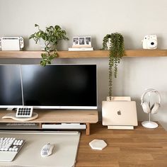 a desk with a computer monitor, keyboard and mouse on it in front of some shelves