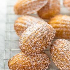 powdered sugar covered donuts on a cooling rack