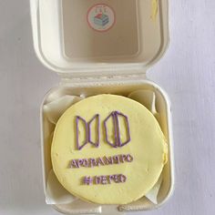 a cake in a box with the word dob written on it and some frosting