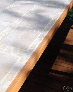 a bench sitting on top of a wooden deck