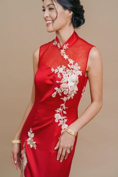 We’ve combined everything that you’re looking for into this stunning mermaid cheongsam–red and gold tones, a sexy sheer neckline and back and beautiful gold phoenix & dragon embroidery. This dress hugs your curves in all the right places and finishes with a delicately embroidered train. Groom's outfit recommendation: Pair this with our Red Qin Jacket. Accessory recommendation: Pair this with our Blossom Hairpin. This dress is named after Chanel Miller (Chinese name is Zhang Xiao Xia), a writer a Red Sleeveless Fitted Cheongsam, Red Fitted Cheongsam For Festive Occasions, Red Fitted Sleeveless Cheongsam, Fitted Red Cheongsam For Festive Occasions, Festive Fitted Red Cheongsam, Festive Red Fitted Cheongsam, Chinese Wedding Dress Cheongsam, Chanel Miller, Red Chinese Wedding