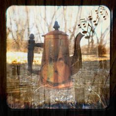 an old teapot with music notes on it sitting next to a fire hydrant