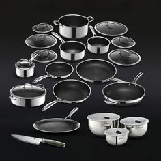 an assortment of pots and pans on a black background