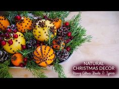 a bowl filled with oranges and pine cones