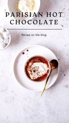 a white plate topped with chocolate next to a bowl of whipped cream and spoons