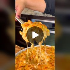 a person is adding cheese to a casserole dish