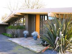 two large blue vases sitting in front of a house