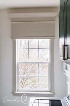 a kitchen window with the blinds closed