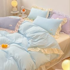 a bed with blue sheets and pillows on it