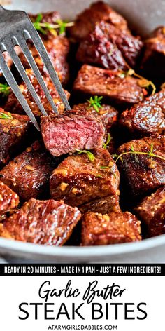 steak bites in a white bowl with a fork and text overlay that says garlic butter steak bites