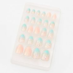 Serious glamour will be right at your fingertips with this on-trend set of faux nails. Stiletto-shaped nail set features a mix of mint ombre confetti and blush glitter designs. Easy to apply, just press on and go! Press On Nails Shape: Stiletto Pack Size: 24 Material: Plastic - Claire's Ombre Mint Glitter Stiletto Press On Vegan Faux Nail Set - 24 Pack Color: Orange.  Age Group: kids. Claire's Fake Nails, Claire's Nails, Fake Nails For Kids, Bitty Baby American Girl, School Wishlist, Faux Nails, Nails Shape, Glitter Stilettos, Nails Stiletto