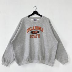 Vintage Oklahoma State University Sweatshirt Oklahoma State Crewneck Oklahoma Sweater Pullover Oklahoma State Cowboys Print Logo XXLarge 𝐁𝐫𝐚𝐧𝐝 :- Oklahoma State University  𝐒𝐢𝐳𝐞 𝐓𝐚𝐠 :- XXLarge Manual Measurement :- 𝐖𝐈𝐃𝐓𝐇 (armpit to armpit) :- 29 inches / 74cm 𝐋𝐄𝐍𝐆𝐓𝐇 (shoulder to end of garment) :- 26 inches / 66cm 𝐂𝐨𝐧𝐝𝐢𝐭𝐢𝐨𝐧 :- Good Condition 8/10.                      - Minor Defect Stain Refer Picture.                      - Colors Might Be Different Due To Light Gray Oversized Sweater For College, Oversized Gray Sweater For College, Thrift Wishlist, State Crewneck, Cowboys Logo, Oklahoma State Cowboys, Oklahoma State University, University Sweatshirts, Oklahoma State