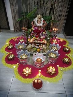 a decorated table with candles and decorations on the floor for diwaling or decorating