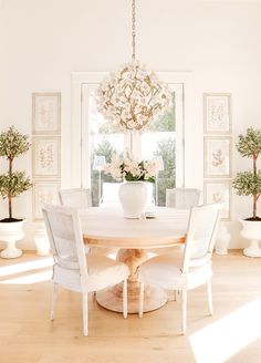 a dining room table with chairs and a chandelier