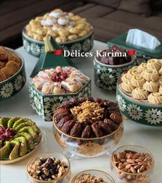 a table topped with lots of different types of desserts and pastries in bowls