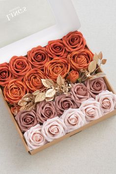 an open box filled with different colored flowers