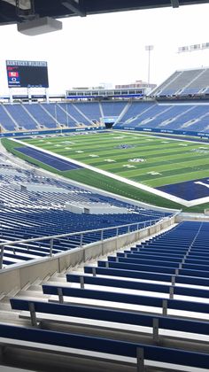 an empty football stadium filled with blue seats