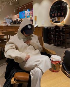 a person sitting in a chair with a hood on