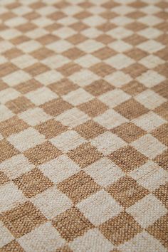 a close up view of a brown and white checkerboard pattern on the fabric