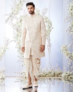 This rose gold sherwani set features all over gota embroidery on a raw silk base. It is paired with a detailed cotton silk kurta and a dhoti pant. Complimenting footwear is also available.From Seema Gujral's Tuscan Summer collection. DELIVERY TIMEPlease allow 8-12 weeks for your outfit to arrive.FABRIC DETAILSRaw SilkProfessional cleaning only. Wedding Sherwani With Gota Work In Raw Silk, Festive Sherwani With Gota Work For Reception, Traditional Drape Sherwani With Gota Work In Raw Silk, Traditional Raw Silk Sherwani With Gota Work, Eid Raw Silk Sherwani With Gota Work, Traditional Sherwani With Gota Work In Raw Silk, Wedding Sherwani With Gota Work, Transitional Wedding Sherwani With Gota Work, Eid Wedding Sherwani With Gota Work