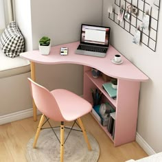 a pink desk with a laptop on it and a chair in front of the desk