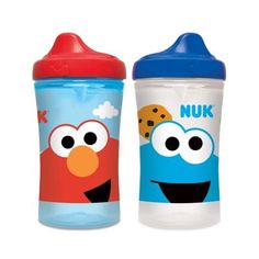 two children's sippy cups with the faces of sesame and cookie cookies on them