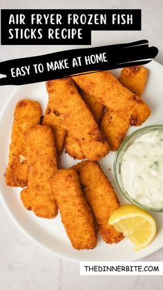 air fryer frozen fish sticks recipe on a plate with lemon wedges and dip