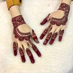 two hands with henna designs on them