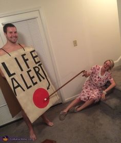 a man pulling a woman on the floor with a life alert sign