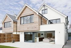 a modern house with large windows and wooden sidings