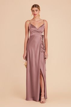 a bridesmaid in a long, spaghetti - neck dress with side slits