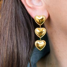 Love, Love, Love! These triple heart dangles give you a little extra this holiday season and with their subtle gold design and high quality materials, you'll easily wear them year-round! Measures 1.75" x 0.5" 18K Gold Plating Stainless Steel Posts Personalized Gold Heart Earrings, Triple Heart, Girly Jewelry, Gold Design, Statement Earrings, 18k Gold, Gold Plate, Plating, Gold