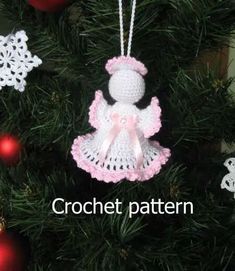 a crocheted christmas ornament hanging from a tree with ornaments around it