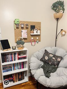 a room with a chair, bookshelf and various items