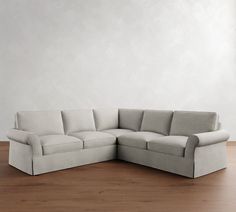 a white couch sitting on top of a wooden floor