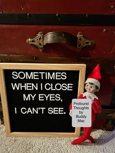 an elf is holding a sign in front of a suitcase with the words sometimes when i close my eyes, i can't see