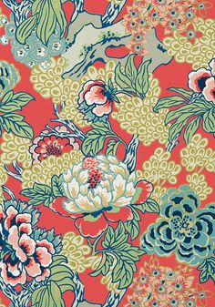 an orange and blue flowered fabric with birds flying over the floral design on it