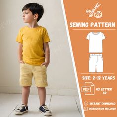 a young boy standing in front of a wall with sewing pattern on it's chest